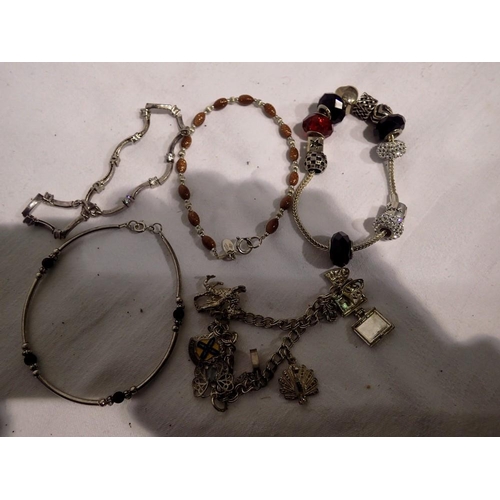 1082 - Five 925 silver bracelets, including a charm bracelet, five charms, and a Rhona Sutton example. UK P... 