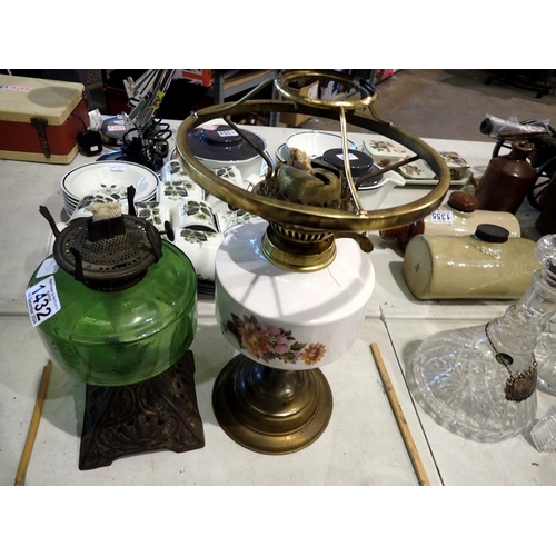 1432 - Two oil lamps, one ceramic floral patterned and one with a green glass reservoir and Art Nouveau met... 