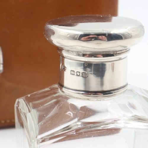 73 - Leather cased set of three cut glass bottles with hallmarked silver screw-tops. Bottle size: H: 12 c... 