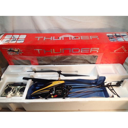 2128 - Boxed Thunder RC Helicopter #FZ2883 by The Flyzone, storage wear to the box and the blades have been... 