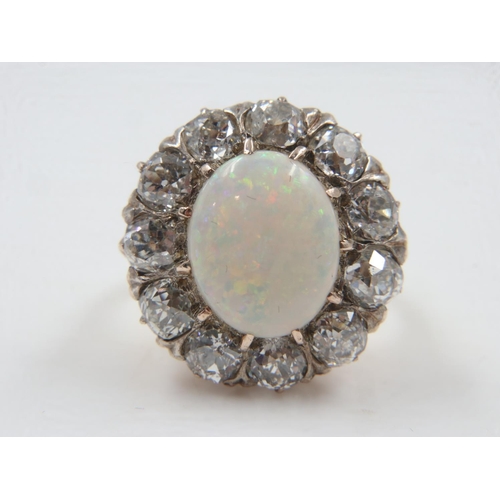 22 - Opal and old cut twelve diamond 18ct gold cluster ring, totalling 3cts, size L/M, 7.1g. UK P&P Group... 