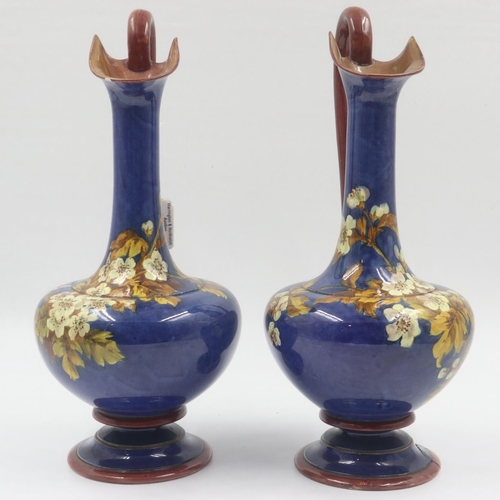 167 - Doulton Lambeth pair of glazed ewers decorated with floral designs, some repairs, each H: 36 cm. UK ... 