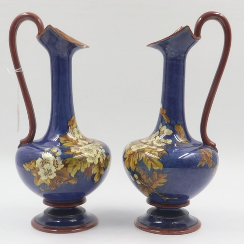 167 - Doulton Lambeth pair of glazed ewers decorated with floral designs, some repairs, each H: 36 cm. UK ... 