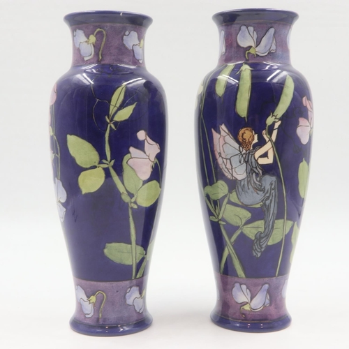 206 - Doulton Lambeth pair of glazed vases, decorated with designs of fairies and flora, repair to one rim... 