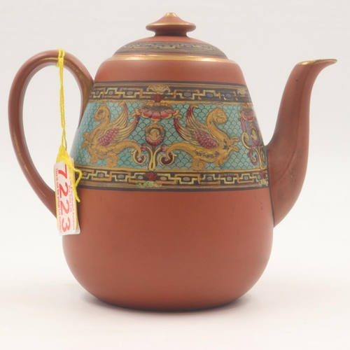 221 - Attributed to Dr Christopher Dresser for Watcombe Pottery, a terracotta teapot and cover decorated w... 