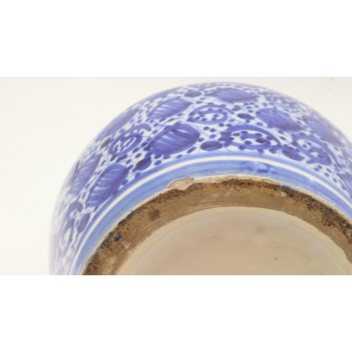 240 - Pair of 19th century Islamic bottle vases, decorated in blue against a white ground, each H: 29cm. U... 