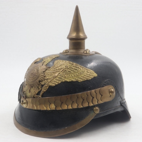 2084 - Replica Imperial German pickelhaube helmet, with brass mounts and badge, with leather chin strap and... 