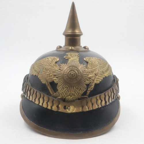 2084 - Replica Imperial German pickelhaube helmet, with brass mounts and badge, with leather chin strap and... 