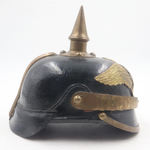 2084 - Replica Imperial German pickelhaube helmet, with brass mounts and badge, with leather chin strap and... 