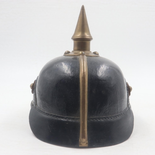 2084 - Replica Imperial German pickelhaube helmet, with brass mounts and badge, with leather chin strap and... 