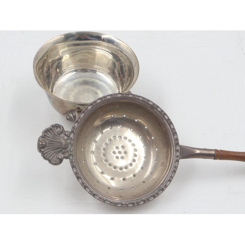 59 - Hallmarked silver tea strainer with turned walnut handle, with associated bowl rest, overall 99g. UK... 