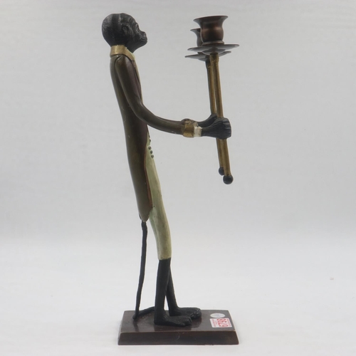 262 - Unusual figural candle stick in the form of an anthropomorphic monkey holding two torches, H: 44 cm.... 