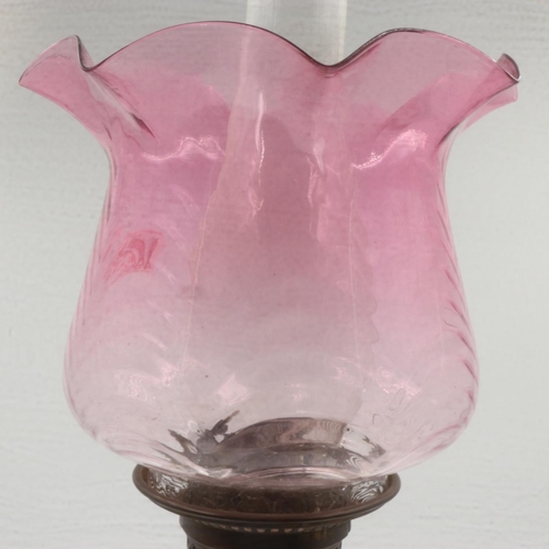 190 - Oil lamp with glass and brass compartments, rose glass shade, H: 66 cm. No damages, cracks or chips.... 