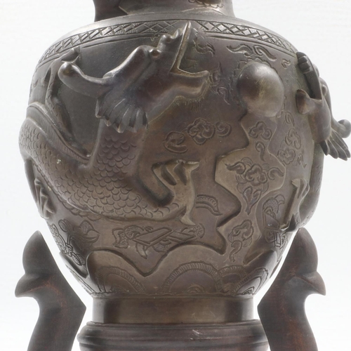 200 - Oriental bronze vase, with four toed Dragon decoration on tripod stand, H: 25 cm. UK P&P Group 2 (£2... 