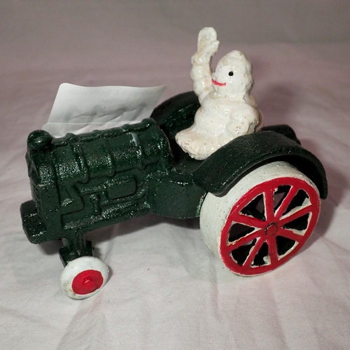 1111 - Cast iron Michelin Man on a Tractor figure, L: 12 cm. UK P&P Group 1 (£16+VAT for the first lot and ... 