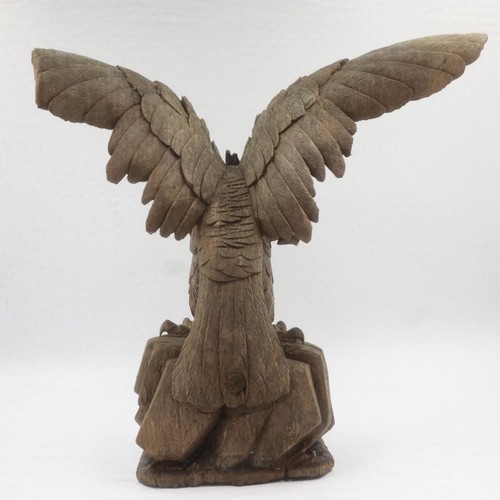 219 - Carved wooden model of eagle on carved base. H: 23cm. UK P&P Group 3 (£30+VAT for the first lot and ... 