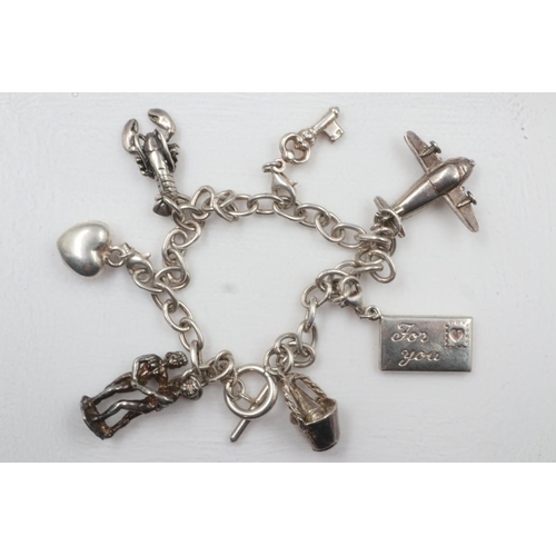 22 - 925 silver charm bracelet with seven charms. UK P&P Group 0 (£6+VAT for the first lot and £1+VAT for... 