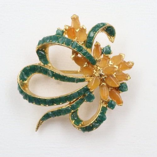 23 - Yellow metal brooch formed with ribbons and flowers set with yellow amber and emeralds. UK P&P Group... 