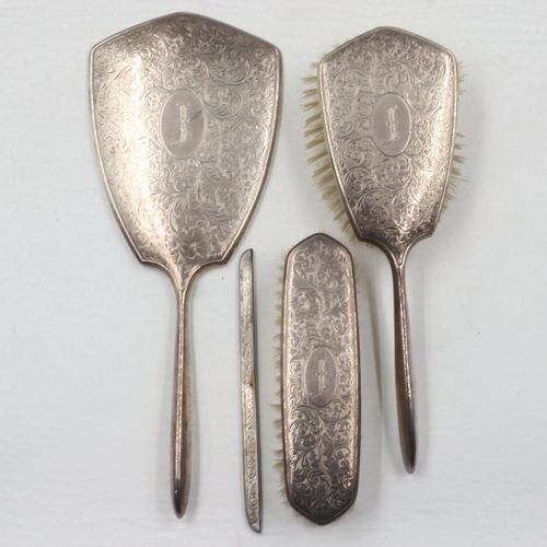 121 - Hallmarked silver dressing set comprising two brushes and mirror, with silver mount for comb (lackin... 