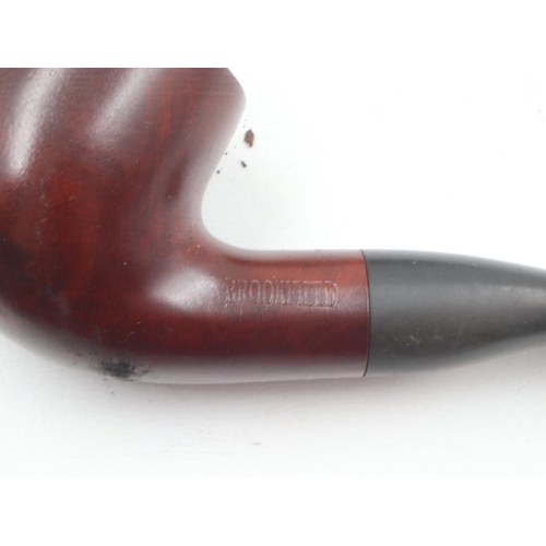 166 - Four mixed smoking pipes including Petersons of Ireland and a meerschaum example, on a ceramic pipe ... 