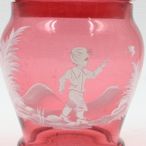 280 - Mary Gregory style cranberry glass covered jar, with enamelled design of a child releasing a dove, H... 