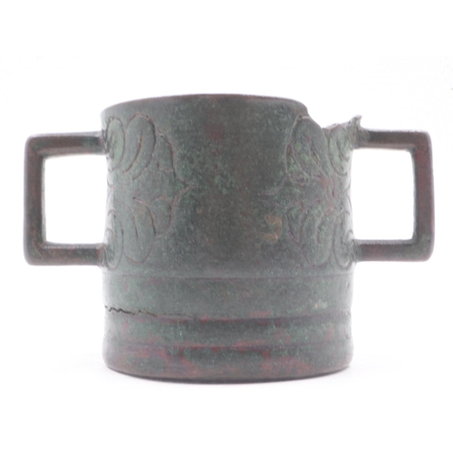 304 - Early Tibetan bronze censer with squared handles and engraved detail to the body, H: 75mm, losses to... 