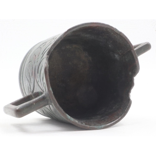 304 - Early Tibetan bronze censer with squared handles and engraved detail to the body, H: 75mm, losses to... 