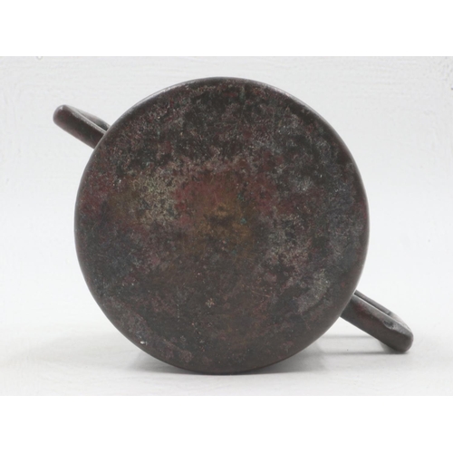 304 - Early Tibetan bronze censer with squared handles and engraved detail to the body, H: 75mm, losses to... 