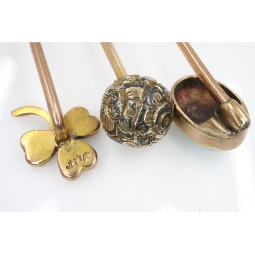 22 - 9ct gold clover leaf stick pin set with seed pearl with two further unmarked gold stick pins, one se... 