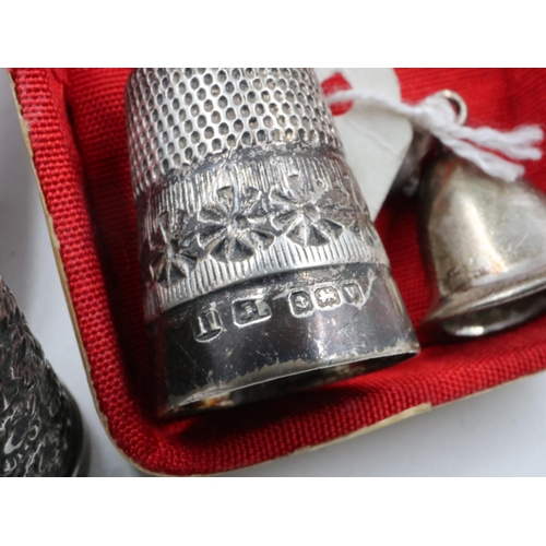 79 - Four hallmarked/925 silver thimbles and two enamelled white metal examples, with a modern silver cha... 