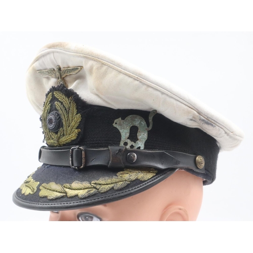 2186 - German WWII Kriegsmarine U-Boat officers visor cap, with flotilla badge, by Steinmek & Hehl, approxi... 