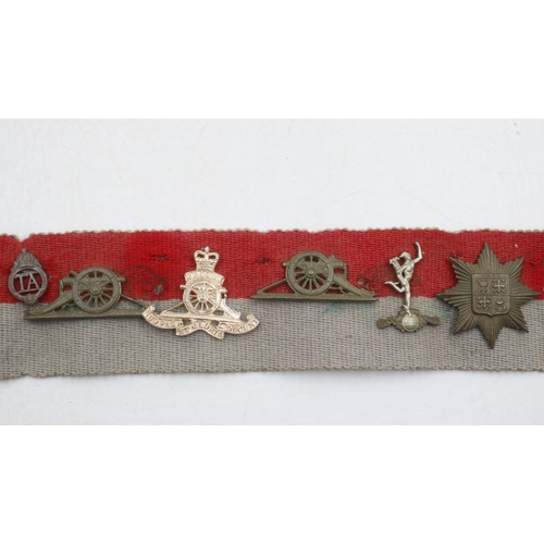 2326 - Collection of WWII and later regimental cap and collar badges affixed to a stable belt, mostly Royal... 