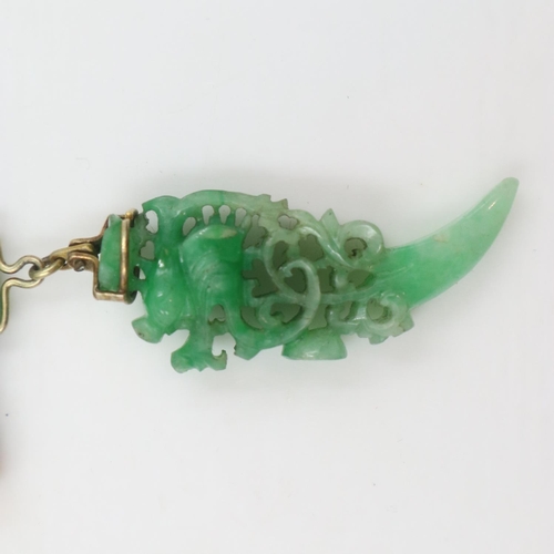 6 - Substantial carved jade pendant, reticulated with the profile of a stylised dragon suspended from a ... 