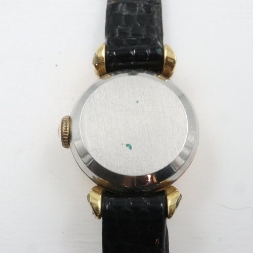 59 - OMEGA: ladies manual wind wristwatch, gold plated case and on a black leather Omega strap, working a... 