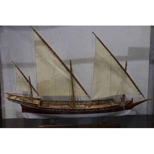 264 - Scratch built wooden three masted sailing vessel in a glass case, L: 70 cm. Not available for in-hou... 