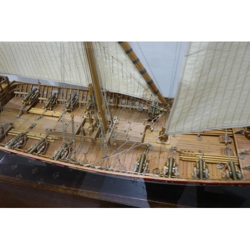 264 - Scratch built wooden three masted sailing vessel in a glass case, L: 70 cm. Not available for in-hou... 