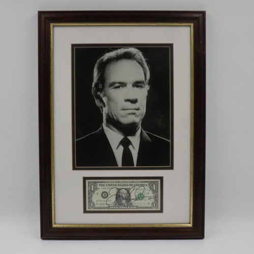 266 - Tommy Lee Jones publicity shot with an autographed one-dollar note, framed with CoA. Not available f... 