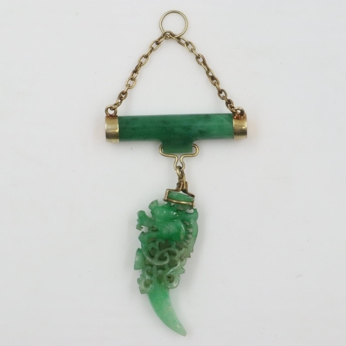 6 - Substantial carved jade pendant, reticulated with the profile of a stylised dragon suspended from a ... 