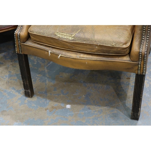 2033 - Early 20th century distressed tan leather Chesterfield wingback fireside armchair. Not available for... 