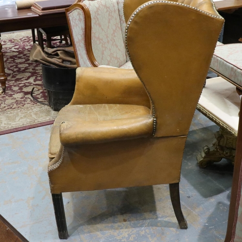 2033 - Early 20th century distressed tan leather Chesterfield wingback fireside armchair. Not available for... 