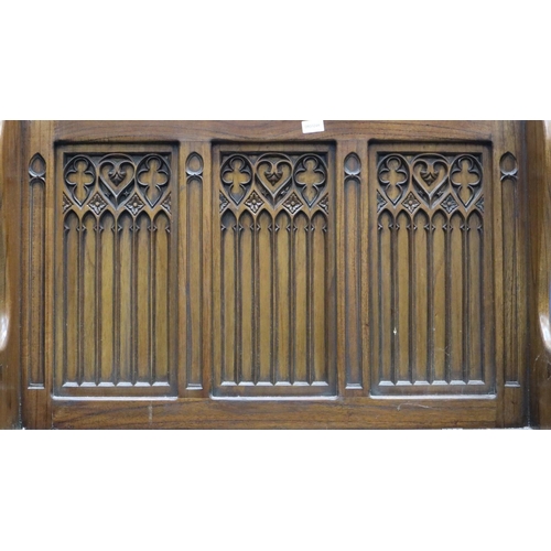 2028 - A 20th century carved oak monk's bench or settle in the 17th century gothic style, with hinged box-s... 