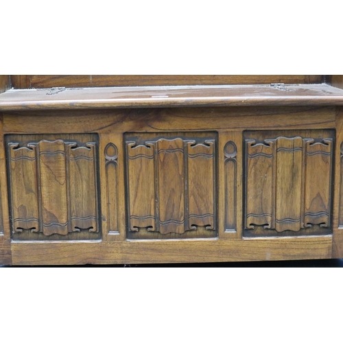 2028 - A 20th century carved oak monk's bench or settle in the 17th century gothic style, with hinged box-s... 