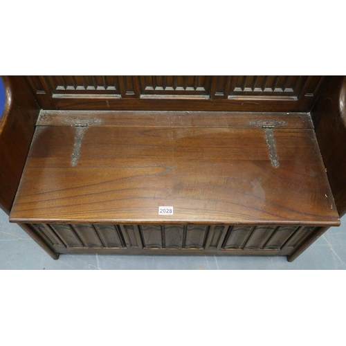 2028 - A 20th century carved oak monk's bench or settle in the 17th century gothic style, with hinged box-s... 