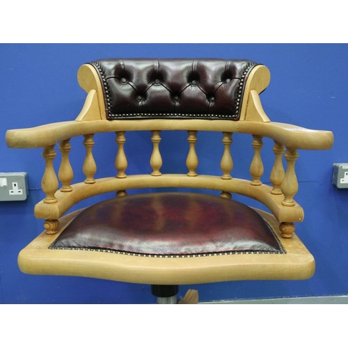 2029 - A modern light elm framed desk chair in the Chesterfield style, revolving and supported on a five-sp... 