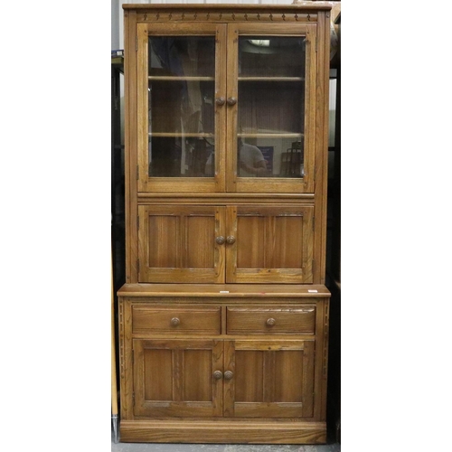 2037 - Ercol Golden Dawn elm bookcase with glazed and panelled cupboard doors. Not available for in-house P... 