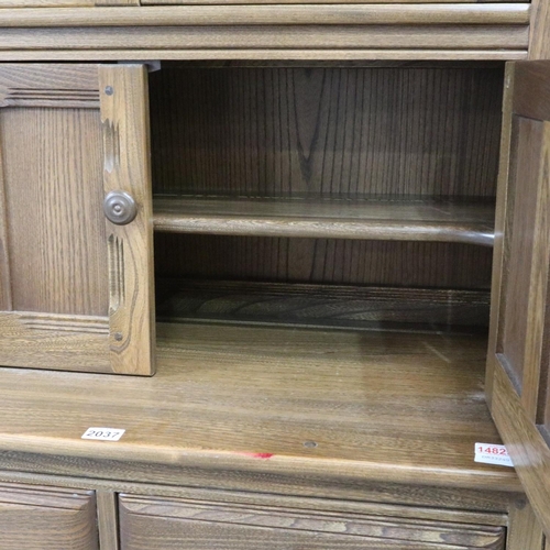 2037 - Ercol Golden Dawn elm bookcase with glazed and panelled cupboard doors. Not available for in-house P... 