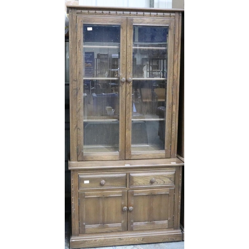 2038 - Ercol Golden Dawn elm bookcase with glazed and panelled cupboard doors. Not available for in-house P... 