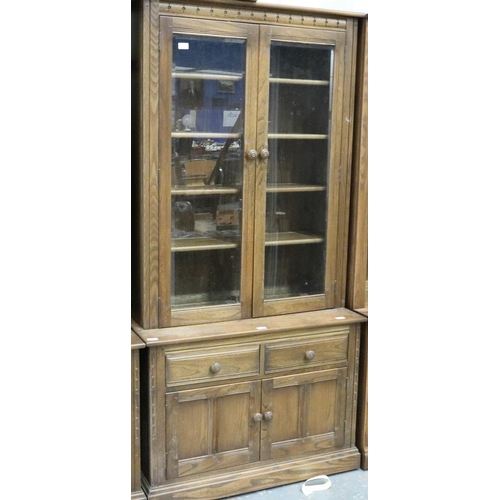 2039 - Ercol Golden Dawn elm bookcase with glazed and panelled cupboard doors. Not available for in-house P... 