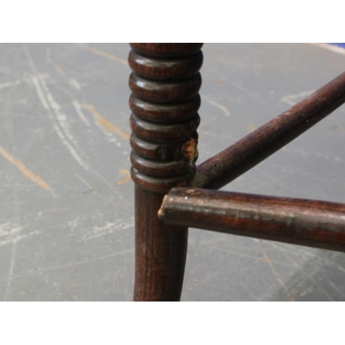 2048 - A pair of Regency period rosewood elbow chairs, each having bergère seats, with turned supports and ... 