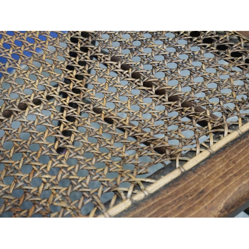 2048 - A pair of Regency period rosewood elbow chairs, each having bergère seats, with turned supports and ... 